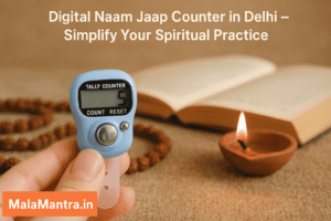 Digital Naam Jaap Counter placed next to a spiritual book and lit diya for mantra chanting – MalaMantra.in
