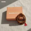 Authentic Chandan Mala with red tassel, natural wood color, for meditation