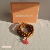 Close-up of smooth, polished Sandalwood beads and Guru bead