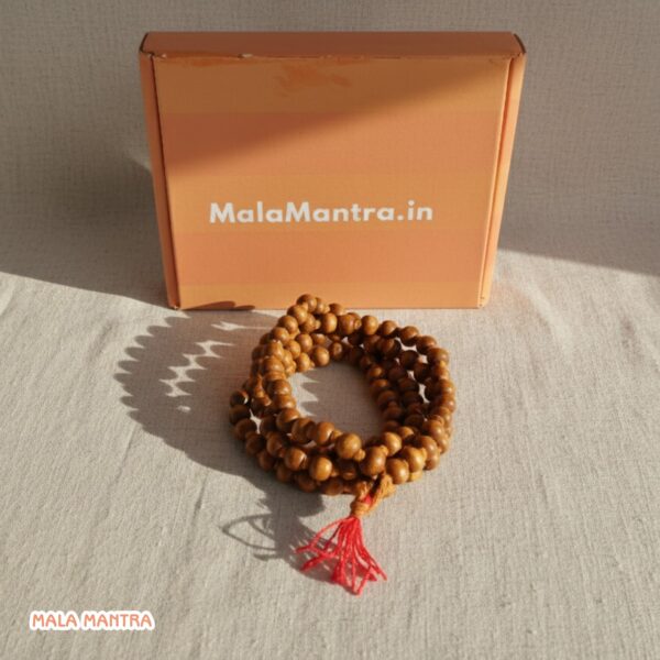 Close-up of smooth, polished Sandalwood beads and Guru bead