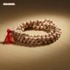 MalaMantra 108-Bead Wood Jaap Mala with vibrant red string and tassel.