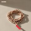 Premium Sandalwood or Tulsi wood meditation beads on red cord.