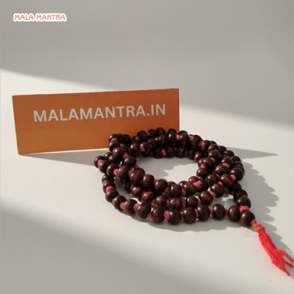 Close-up of smooth 108 Red Sandalwood beads for spiritual practice