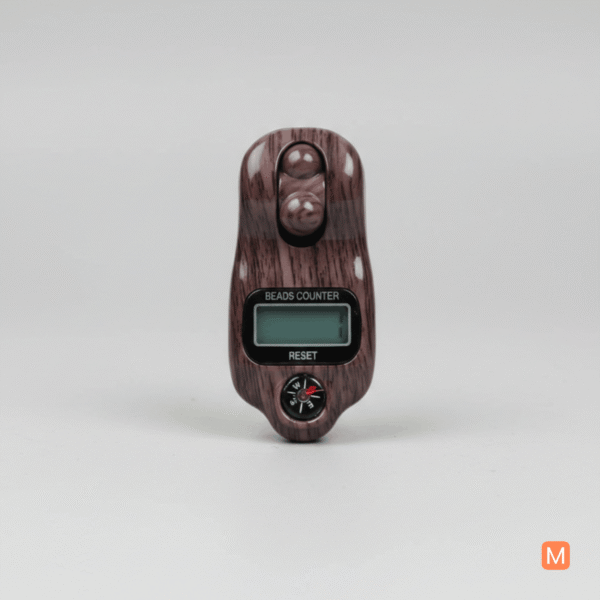 Close-up of the MalaMantra electronic prayer beads showing the LCD display, reset button, and scrolling wheel.