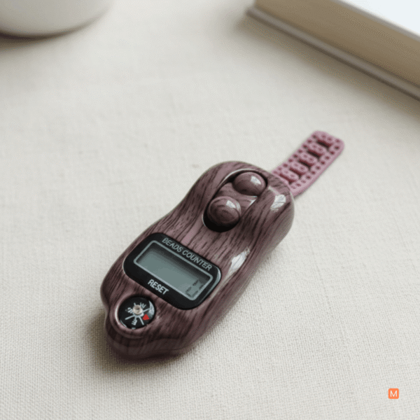 Modern MalaMantra spiritual tool featuring a tactile scroll mechanism and decorative pink tassel strap for portable meditation.